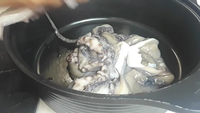 Combine ingredients: In a pot, add the octopus tentacles, onions, chilies (whole or sliced), ginger-garlic paste, galangal, lemongrass root, water, lemon juice, and lemon zest. Add salt.
