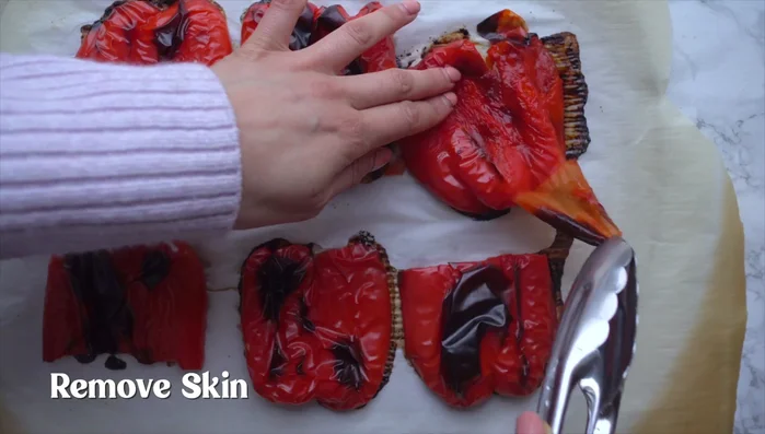 Add the roasted peppers and walnuts to a food processor.