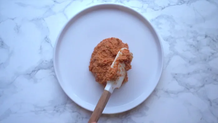 Plate the Muhammara. Drizzle with additional olive oil and pomegranate molasses.