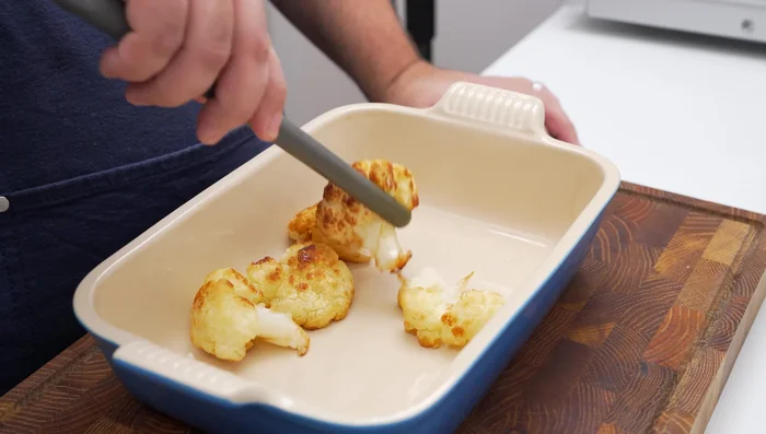 Assemble baked cauliflower: Layer fried cauliflower and browned onions in a baking dish. Pour tahini sauce over everything.