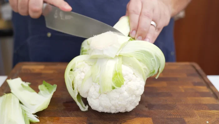Break down cauliflower, removing stalks and leaves, cut into bite-sized florets. Wash and dry.