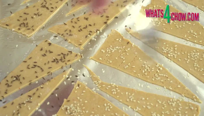 Prick holes into the pastry triangles with a fork. Closer holes create crispier lavash; further apart makes it lighter.
