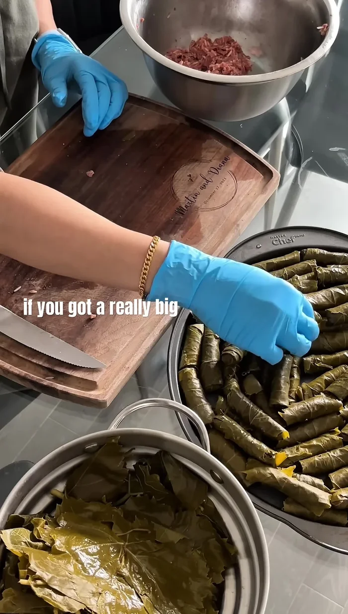 Roll and fold the grape leaf, trimming excess if necessary. This is time-consuming; enlist help!