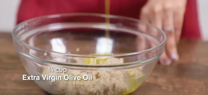 Prepare the dressing: In a bowl, whisk together 1/4 cup of extra virgin olive oil and the juice of 1 1/2 lemons (adjust to taste).