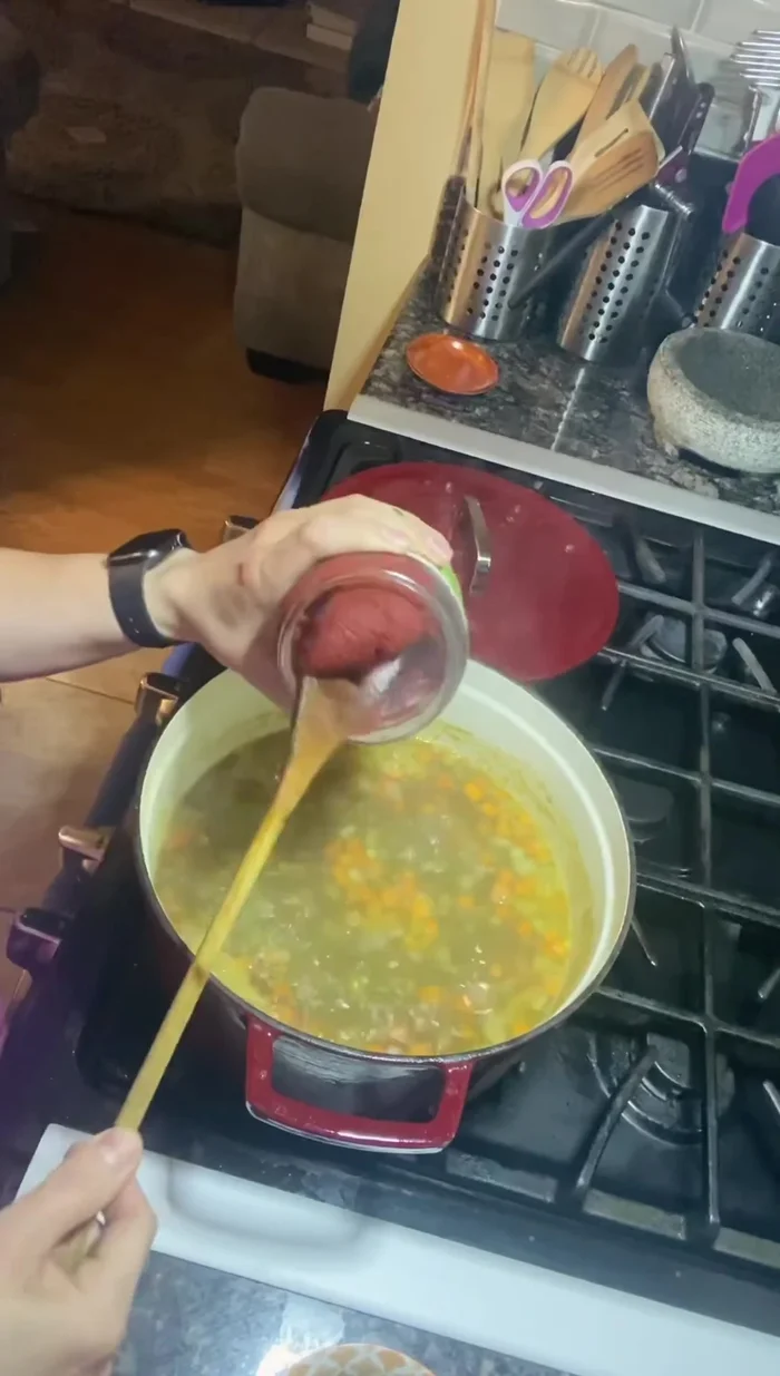 Incorporate the peas and tomato paste: Add the prepared split peas and 1.5 tablespoons of tomato paste to the pot.
